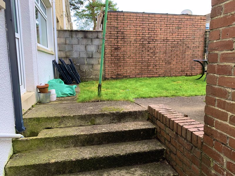 Steps up to the rear garden from the front door ac